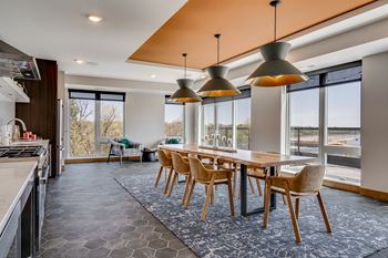 a large dining room with a long wooden table and chairs